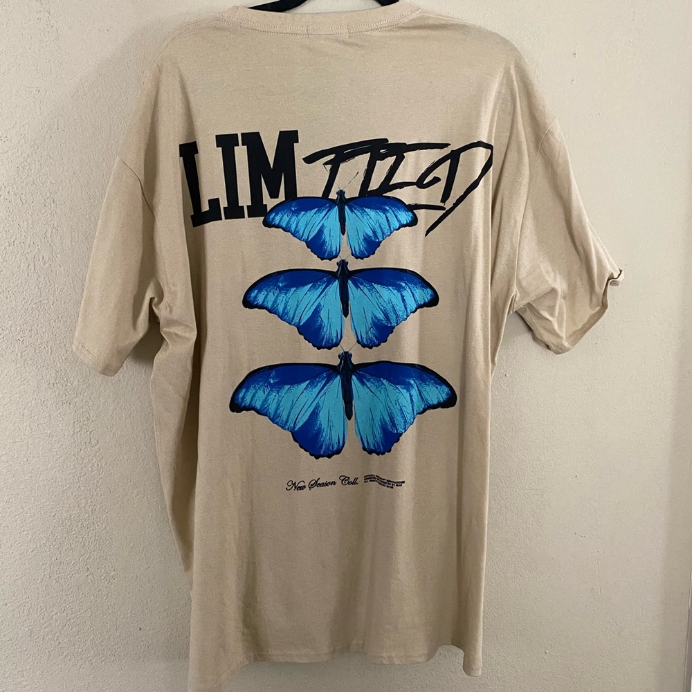 Revolve beige t-shirt with blue butterfly
